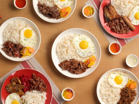 a top view of various Tapa King Favorites with matching vinegar condiments art directed and photographed by Bluethumb