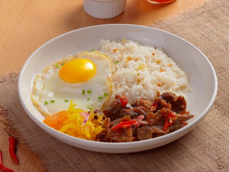 a dish of Spicy and Sweet Tapa King with fried egg, tapa, fried rice, and atchara art directed and photographed by Bluethumb